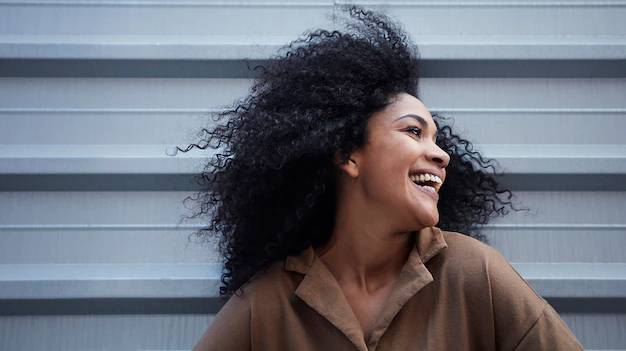 young black woman with afro hair laughing enjoying 150588 175 1